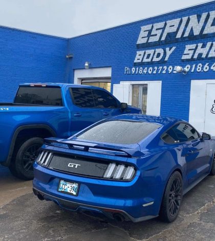 Exterior view of Espino's Body Shop located in Dallas, Texas, showcasing the shop's sign and surrounding area.